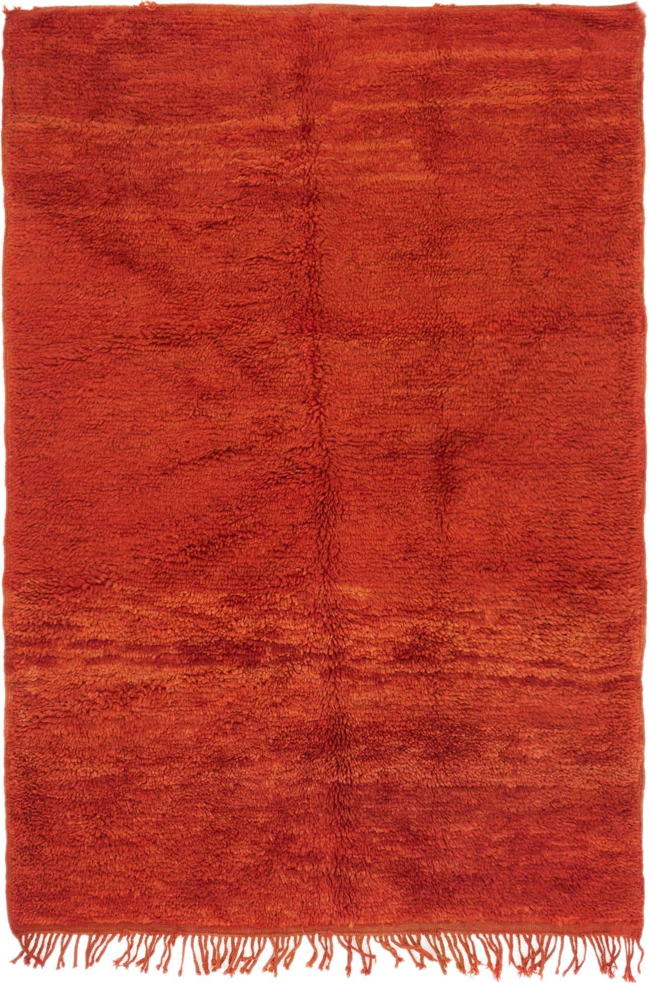 A 4x6 rectangular shag rug in a vibrant red hue, handmade from wool, with a tribal texture.
