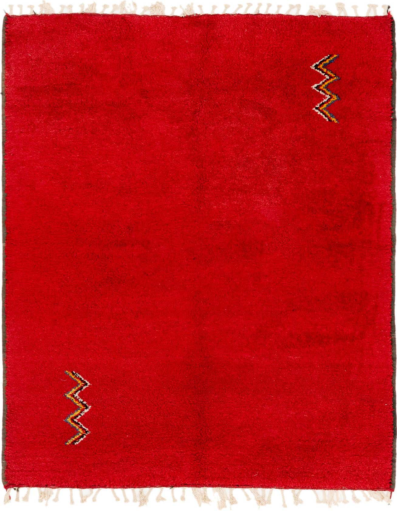 A vibrant 5x8 rectangular red shag rug with two small, colorful tribal zigzag patterns, perfect for a modern living room.