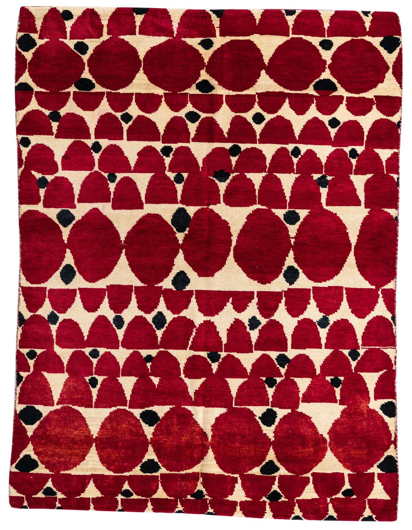 A 5x8 rectangular red and cream shag rug with a modern tribal pattern featuring large red ovals and smaller red and black abstract shapes.