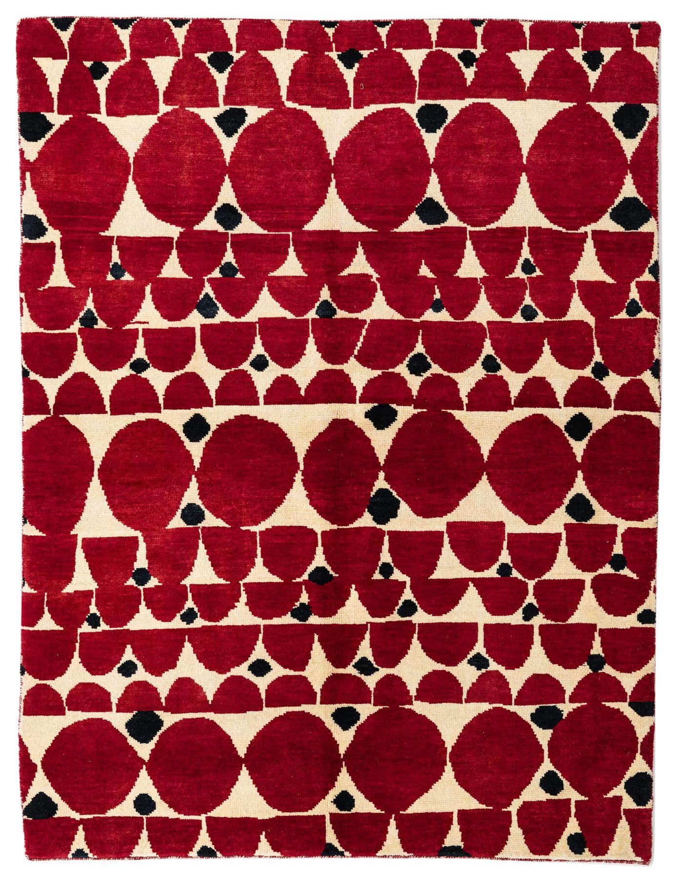 A 5x8 rectangular red and cream wool shag rug with a modern tribal pattern of large and small red geometric shapes and small black dots.