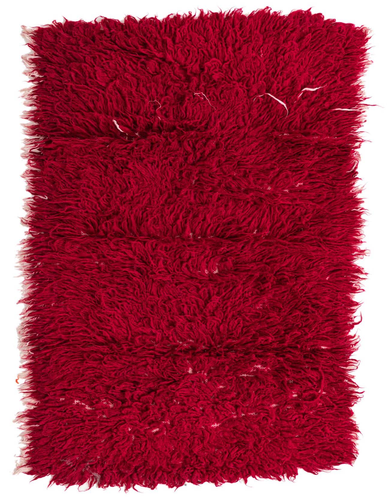 A vibrant 3x5 rectangular red shag wool rug with a thick, plush pile, showcasing its handmade texture.