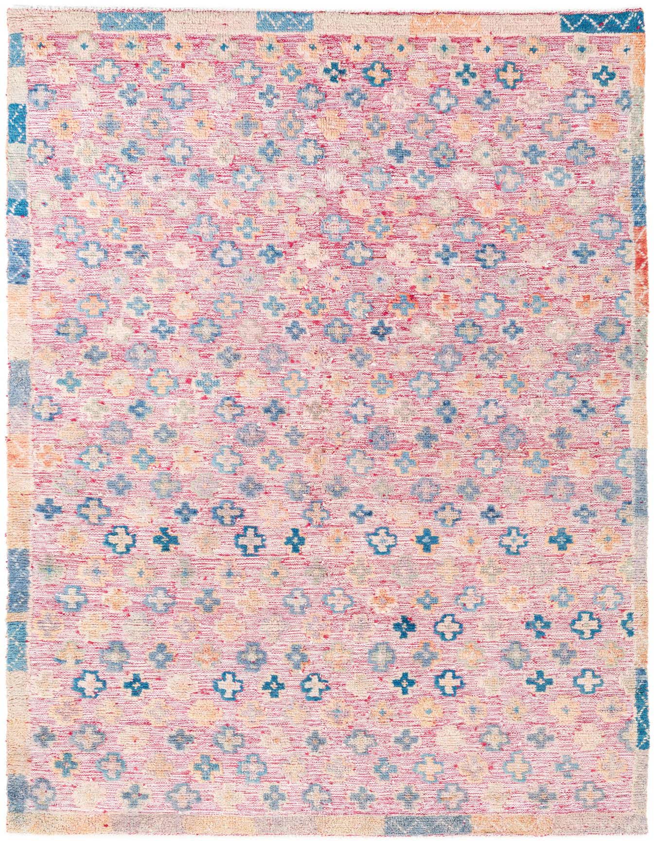 A rectangular 5x8 red Moroccan shag rug with a tribal pattern of blue and yellow abstract shapes.