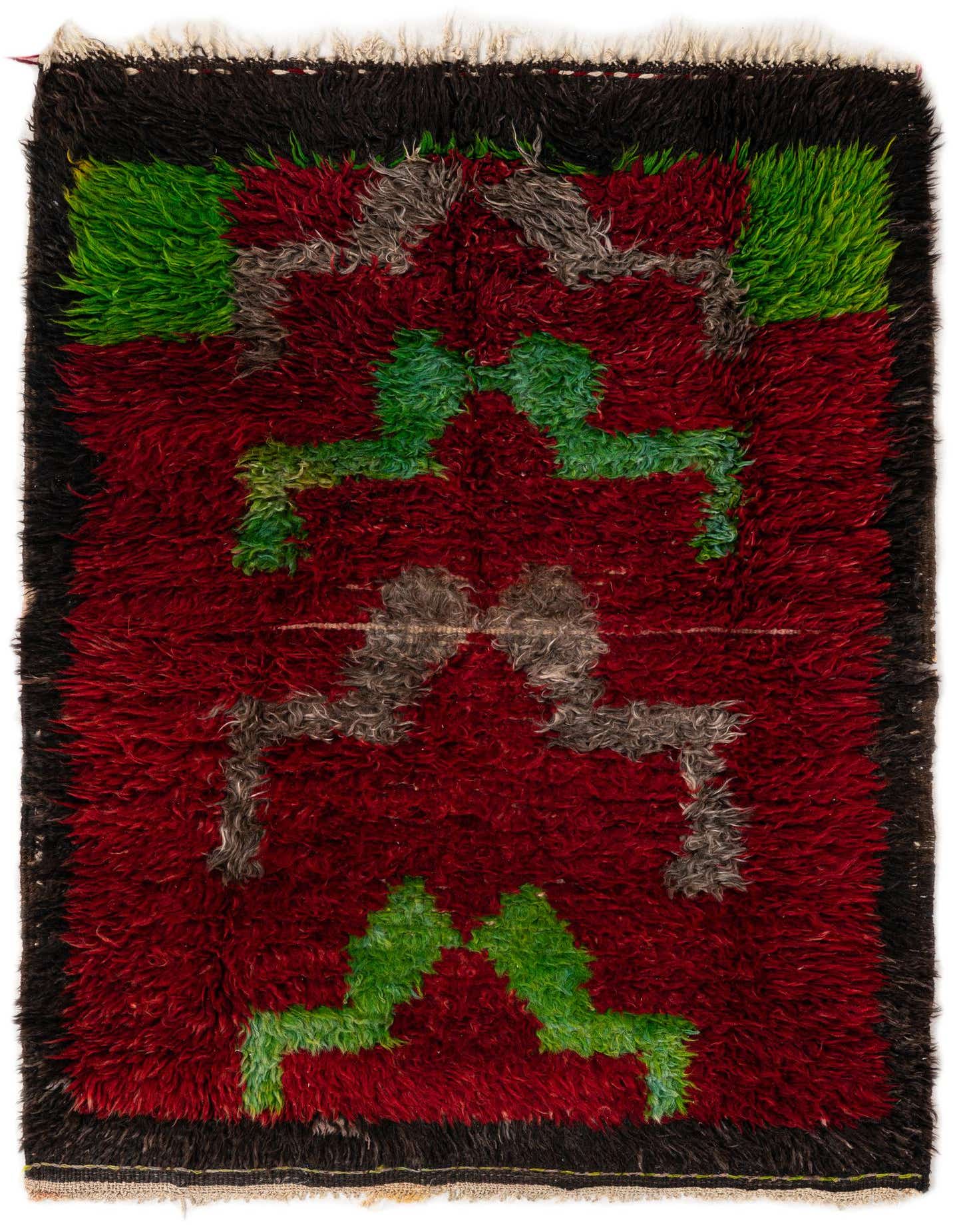 A 3x4 rectangular shag rug featuring a vibrant red field with a black border and abstract green and grey tribal patterns.