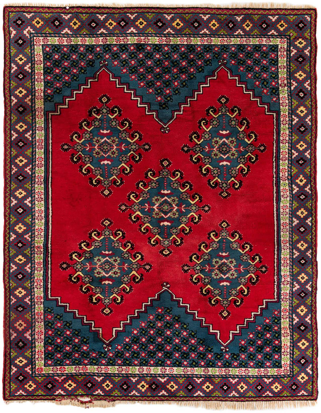 A 7x10 rectangular red wool shag rug with a traditional tribal pattern, featuring a central teal medallion design and intricate borders.