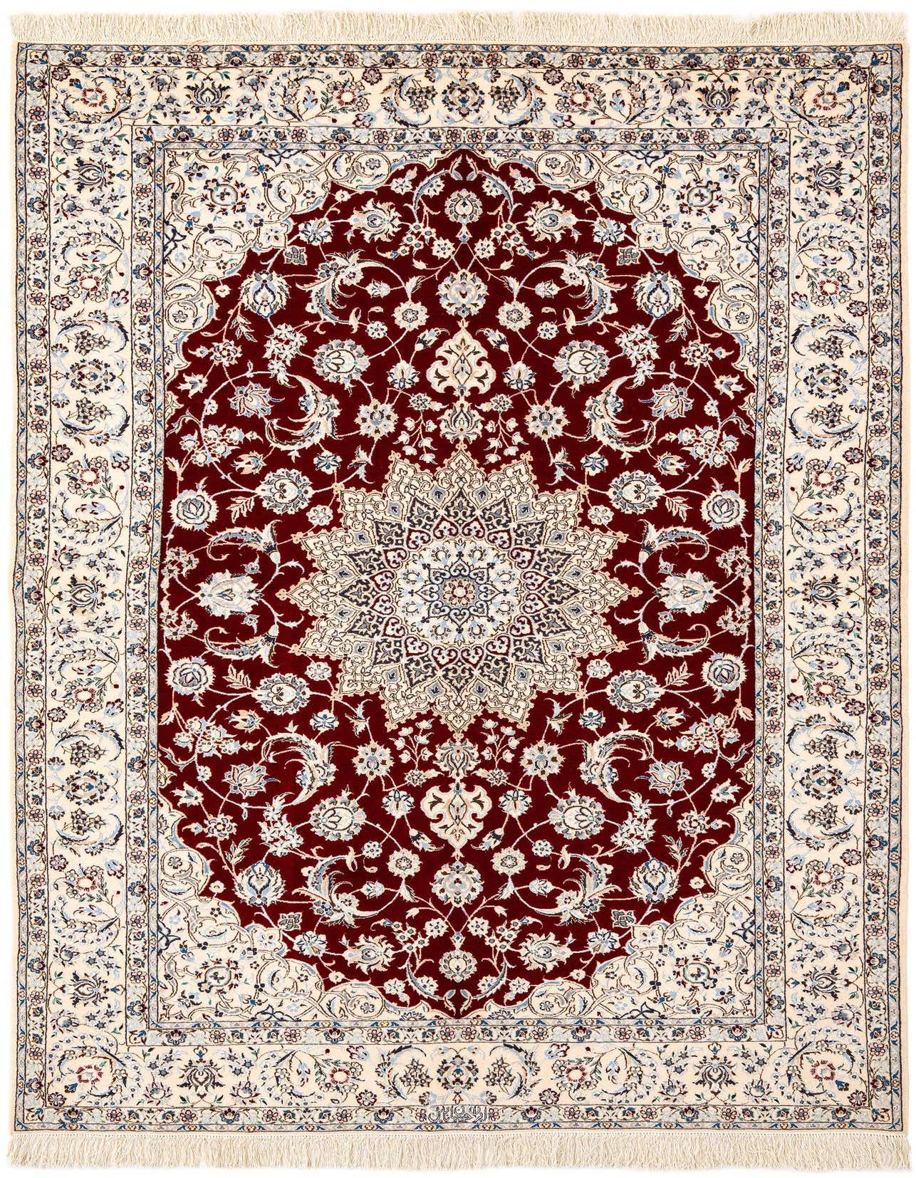 A handmade rectangular Persian rug featuring a rich red field with an intricate cream and blue floral medallion, bordered by a cream frame with complementary patterns.