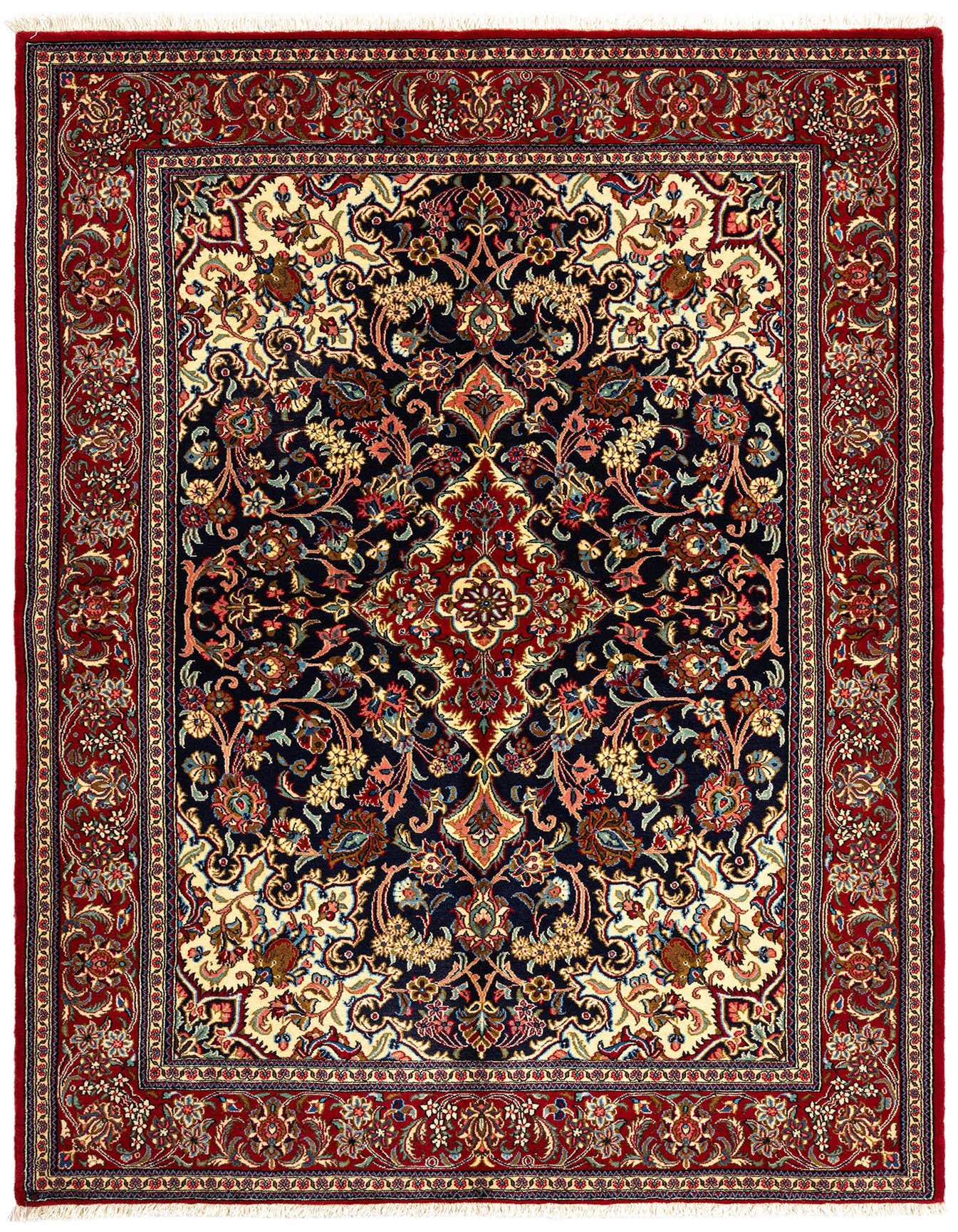 A 5x7 rectangular Persian rug with a rich red border and a dark navy field, featuring intricate floral and medallion patterns in red, gold, and blue.