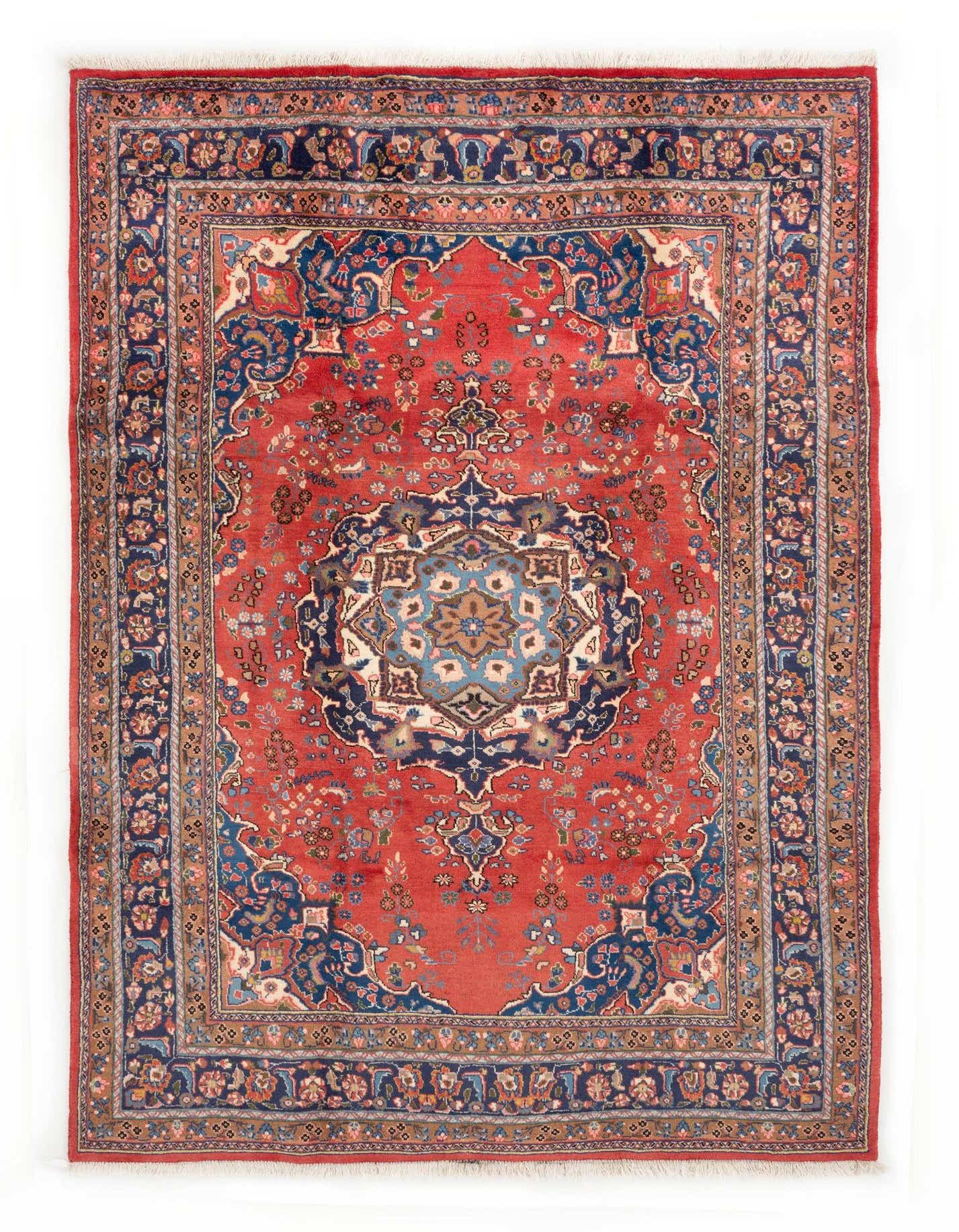 A 6x9 rectangular Sabzevar Persian rug with a rich red field, intricate navy blue border, and a detailed central medallion.