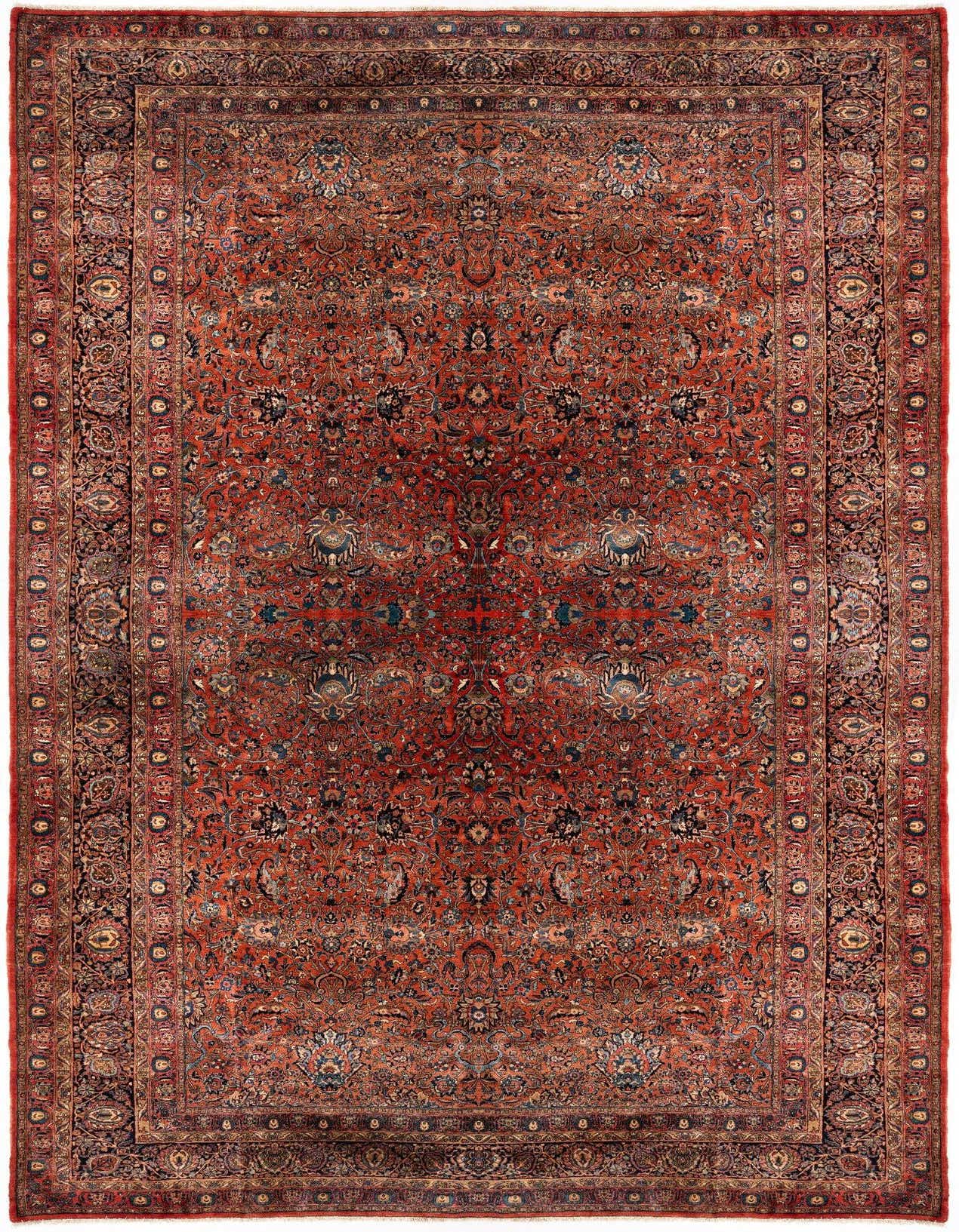 A large rectangular Sarouk palace rug in rich red and navy, featuring intricate traditional floral patterns and a detailed border.