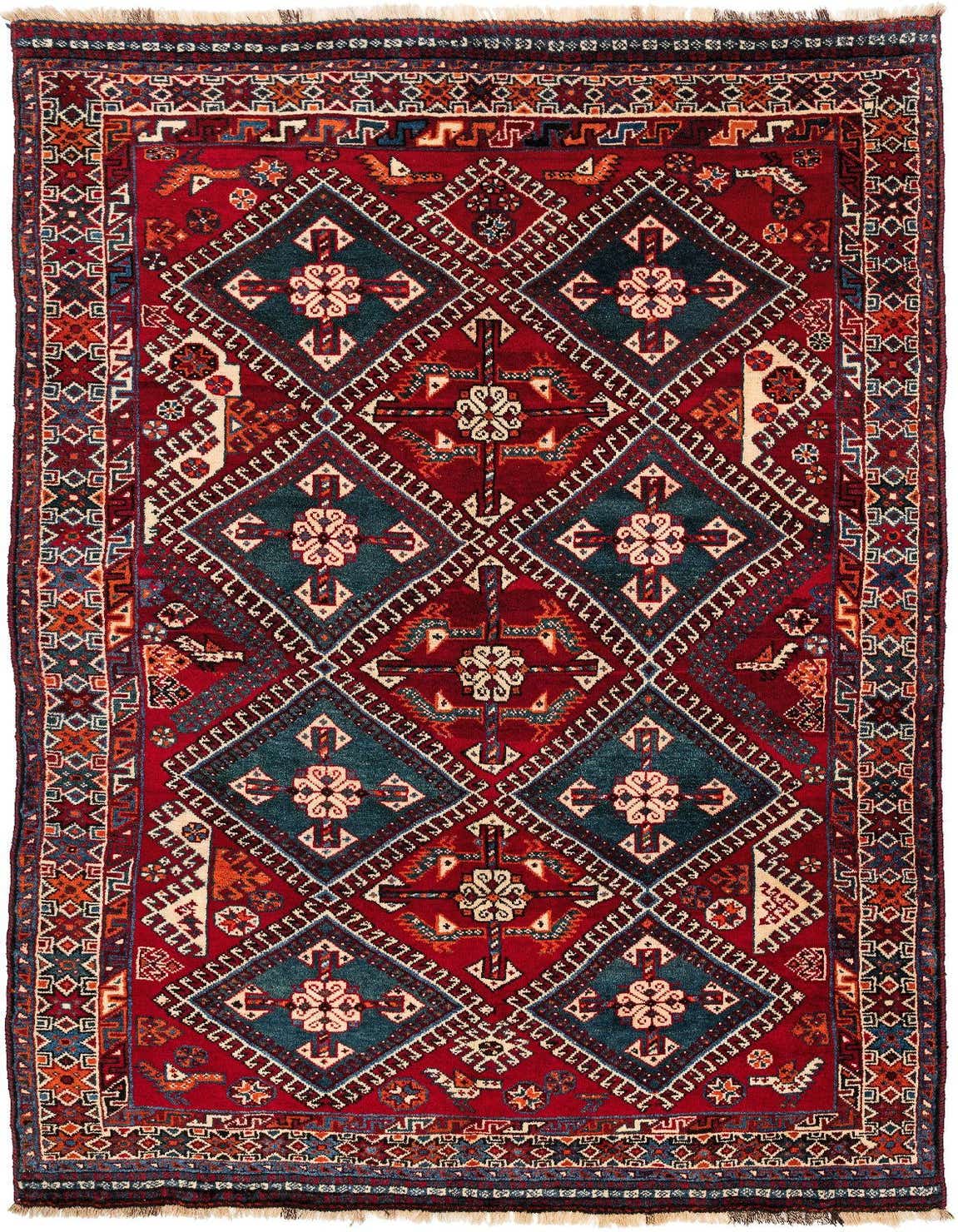 A 5x8 rectangular Shiraz rug featuring a traditional pattern with deep reds and teal diamond motifs.