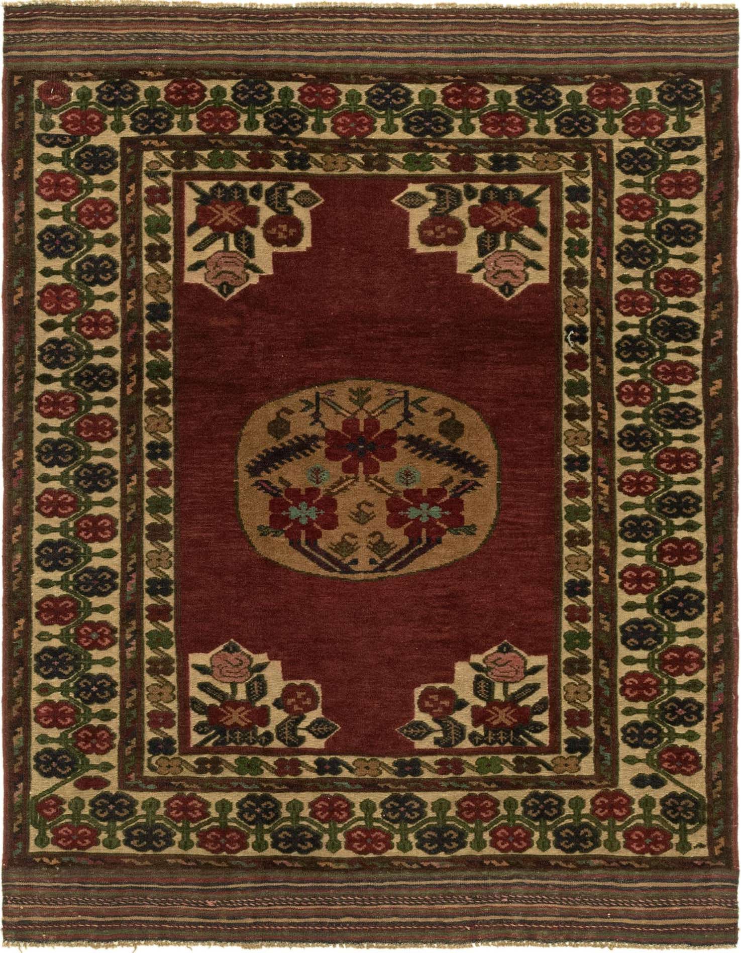 A 4x6 rectangular red wool rug with a traditional botanical medallion pattern and tribal border, ideal for a living room.