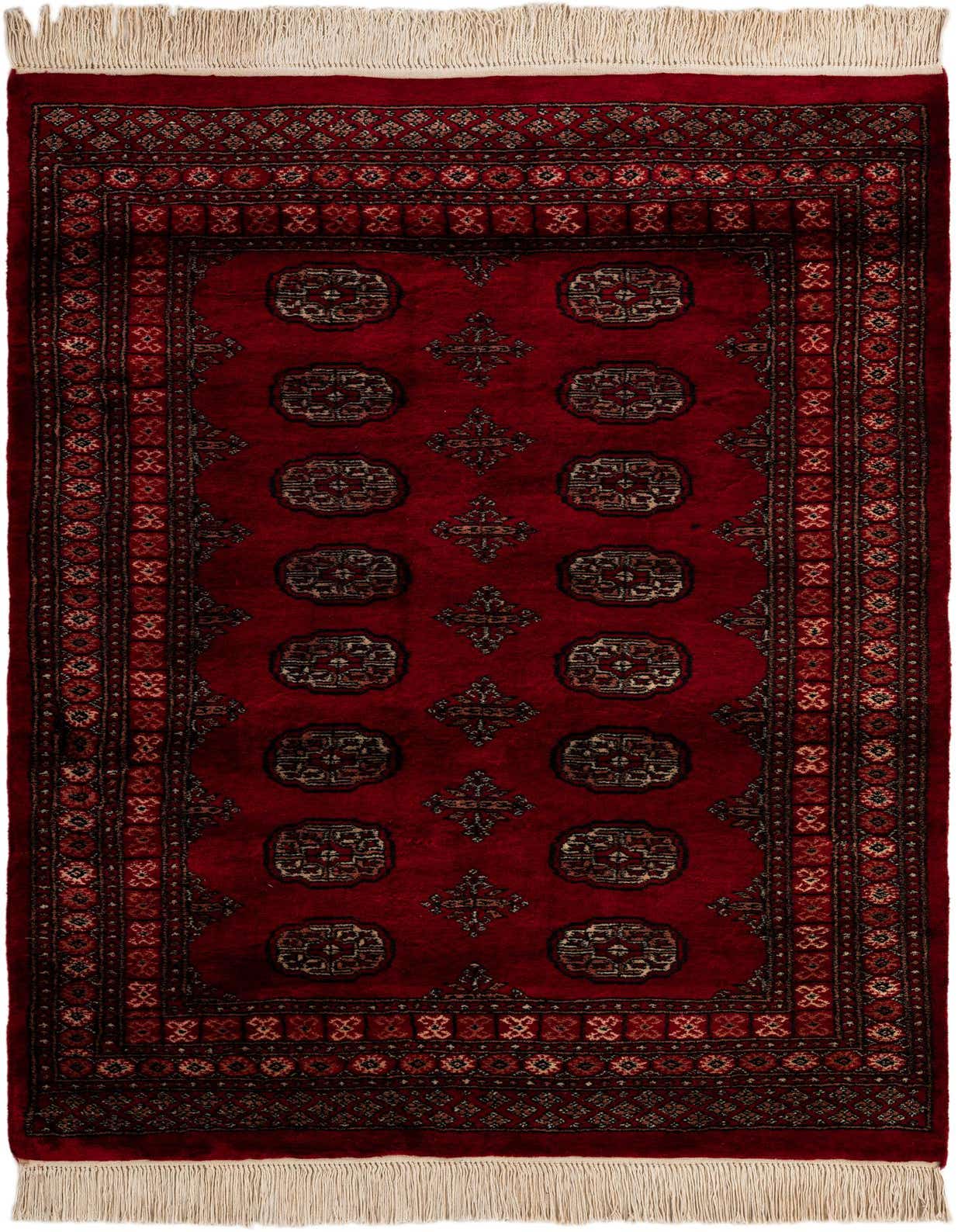 A 4x6 rectangular Torkaman rug in deep red with traditional Persian patterns and fringe, suitable for a living room.