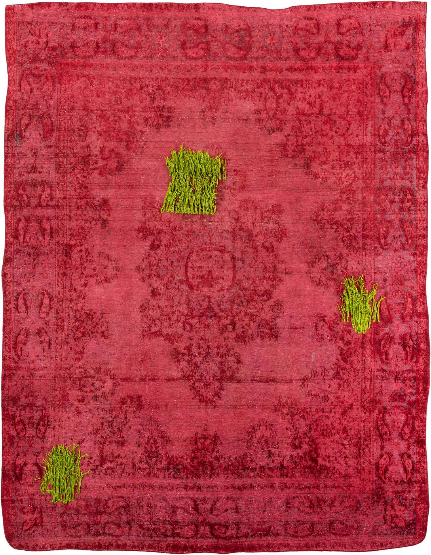 A 9x12 rectangular Ultra Vintage rug in deep red with a distressed Persian pattern, featuring three small bundles of bright green yarn on its surface.