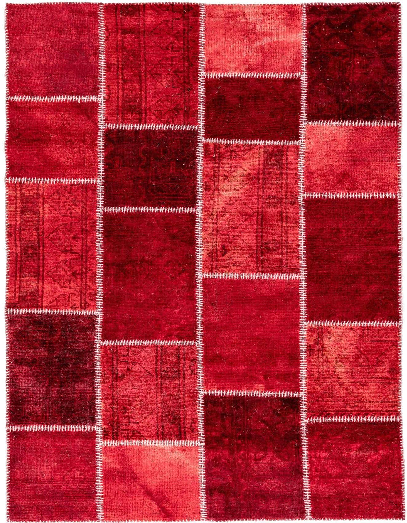 A 4x6 rectangular red wool patchwork rug with varied shades and patterns, stitched together with white thread.