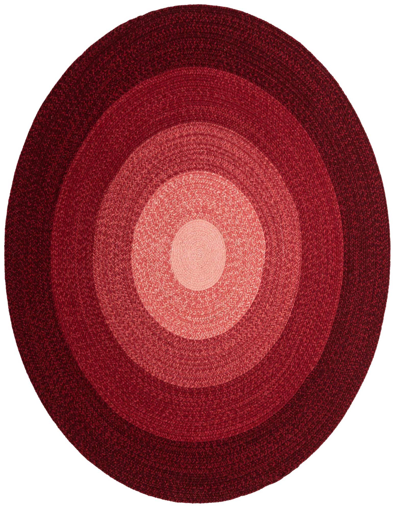 A round, hand-braided wool rug with concentric circles in varying shades of red, from light in the center to dark at the edge.