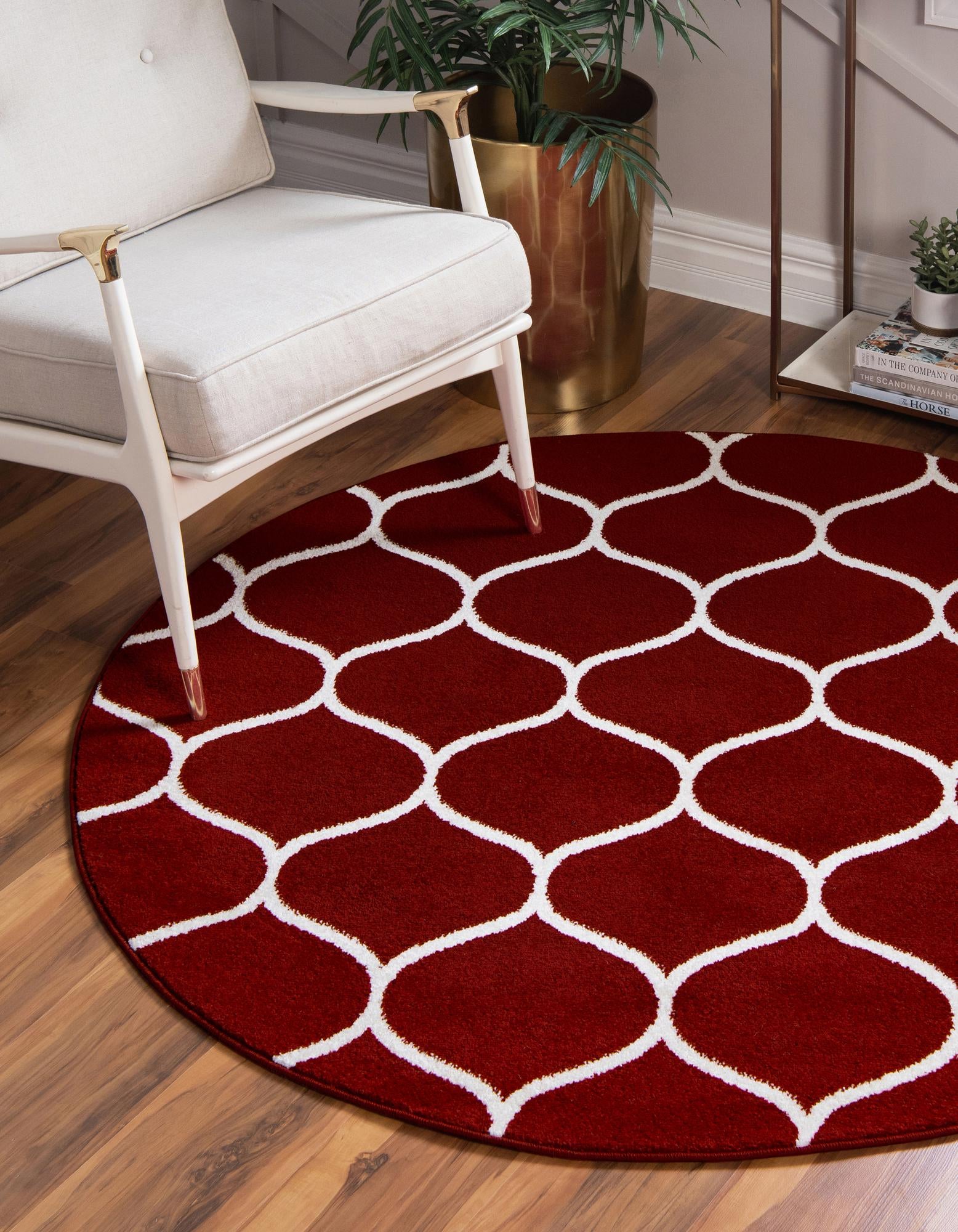 A 5' 3 round red rug with a white modern trellis pattern, suitable for indoor spaces.