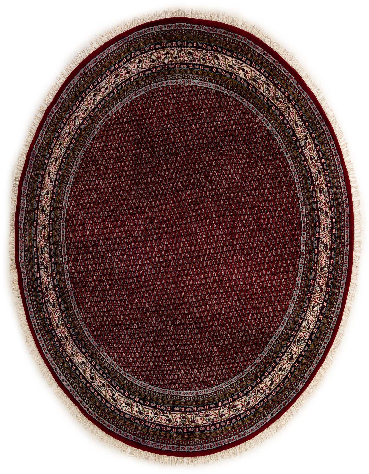 A 7' 10 round Mir rug in deep red with an intricate traditional Oriental border and fringe.
