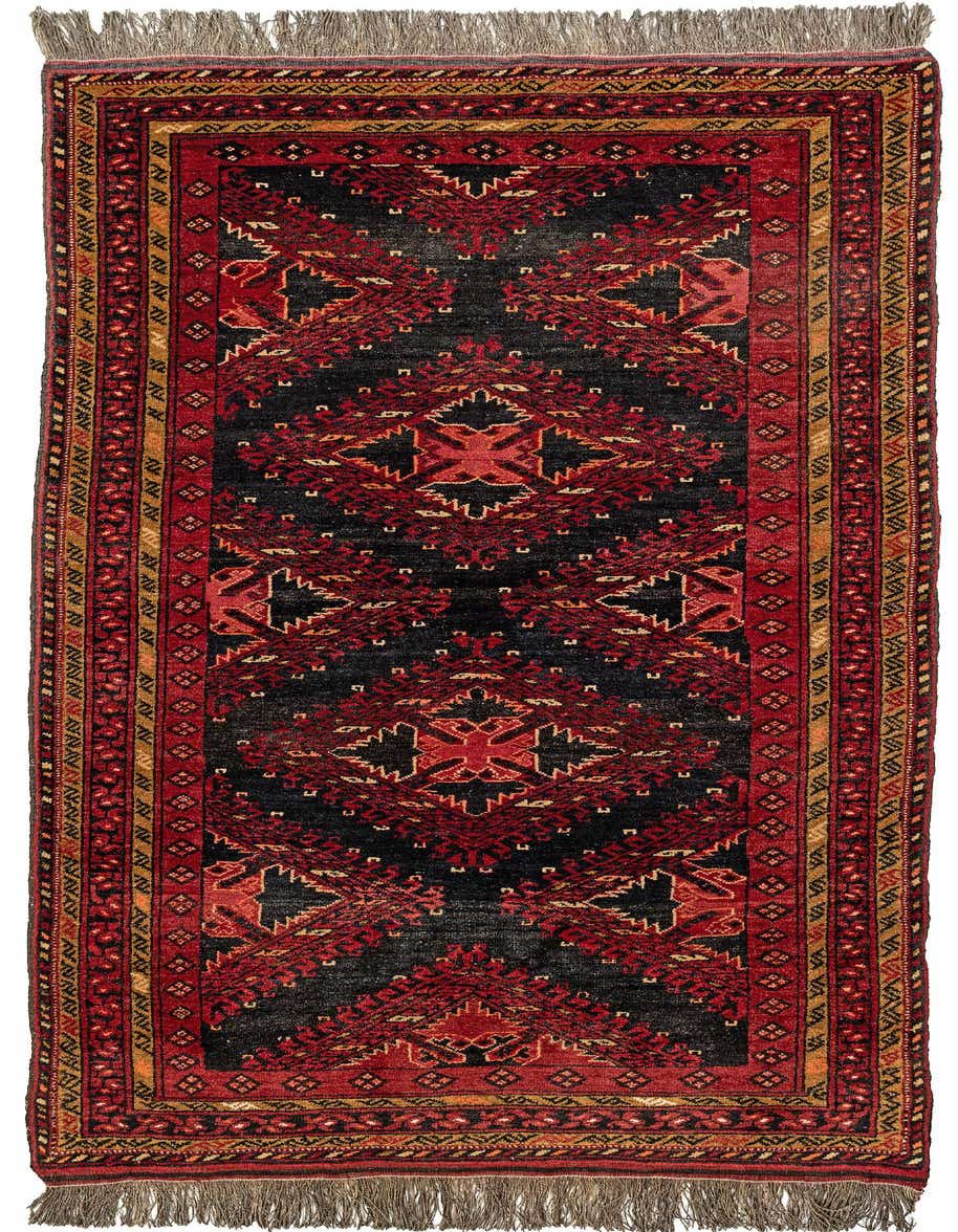 A handmade 7 ft runner rug with a black field and bold red tribal patterns, featuring a red and gold border with fringe.