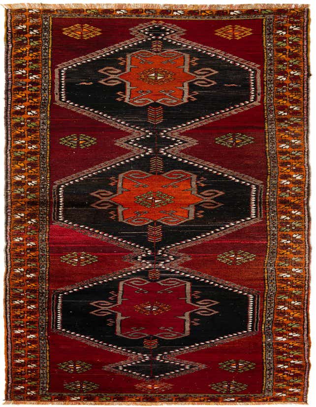 A 13 ft Anatolian runner rug with a deep red background and black, orange, and cream oriental patterns.