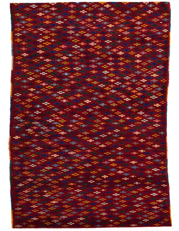 A handmade Balouch 10 Ft Runner rug in red, featuring a vibrant, repeating tribal pattern of small, colorful geometric shapes, ideal for a hallway.