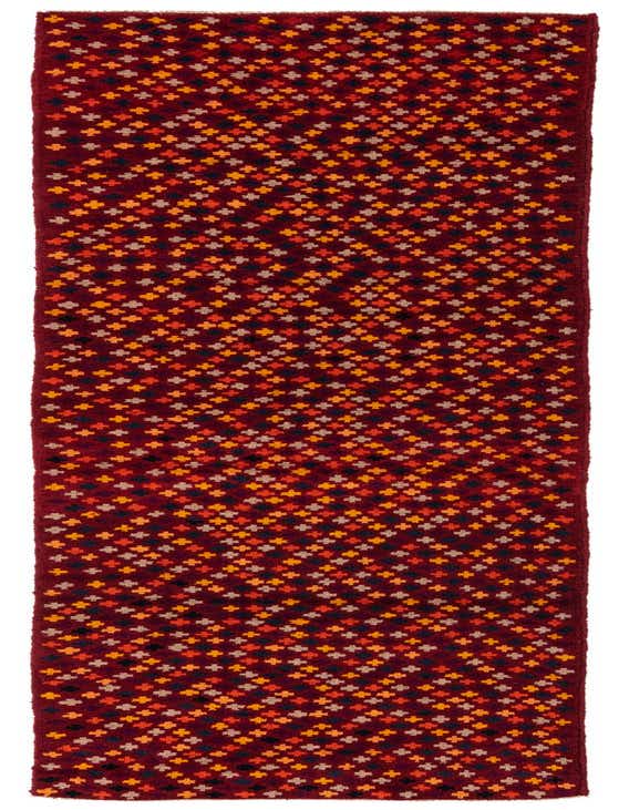 A 10 Ft Balouch runner rug in deep red with a repeating pattern of small tribal motifs in orange, yellow, black, and beige.