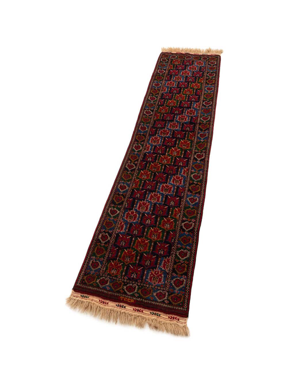 A handmade 8 ft runner rug from the Beshir collection, featuring traditional patterns in deep reds, blues, and greens, with fringed ends.