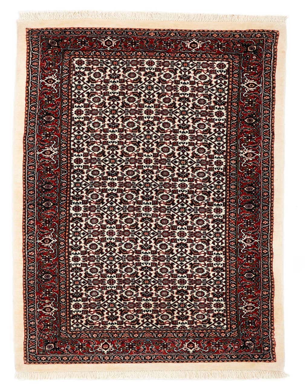 A 5 ft runner rug, handmade from wool and silk, featuring a traditional red and cream intricate pattern with a detailed border and fringe.