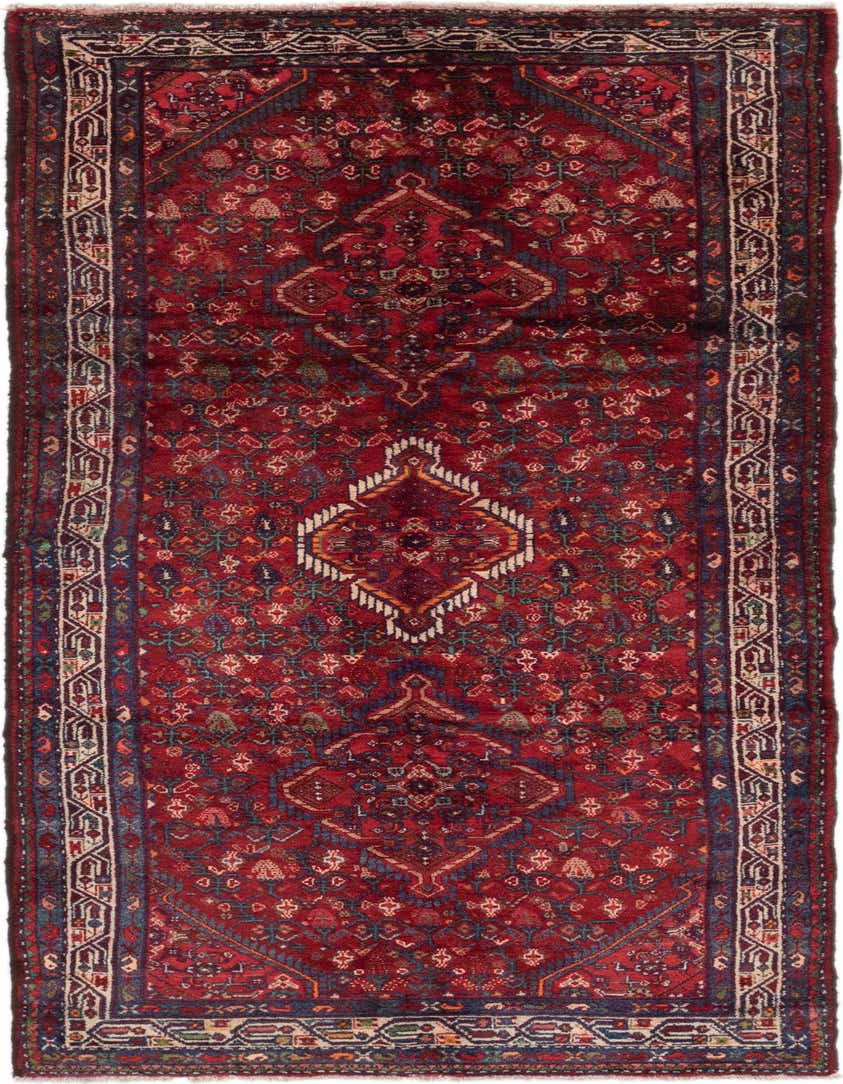 A 10 ft runner rug in traditional Persian style, featuring a deep red field with intricate tribal patterns and a central medallion, ideal for a hallway.