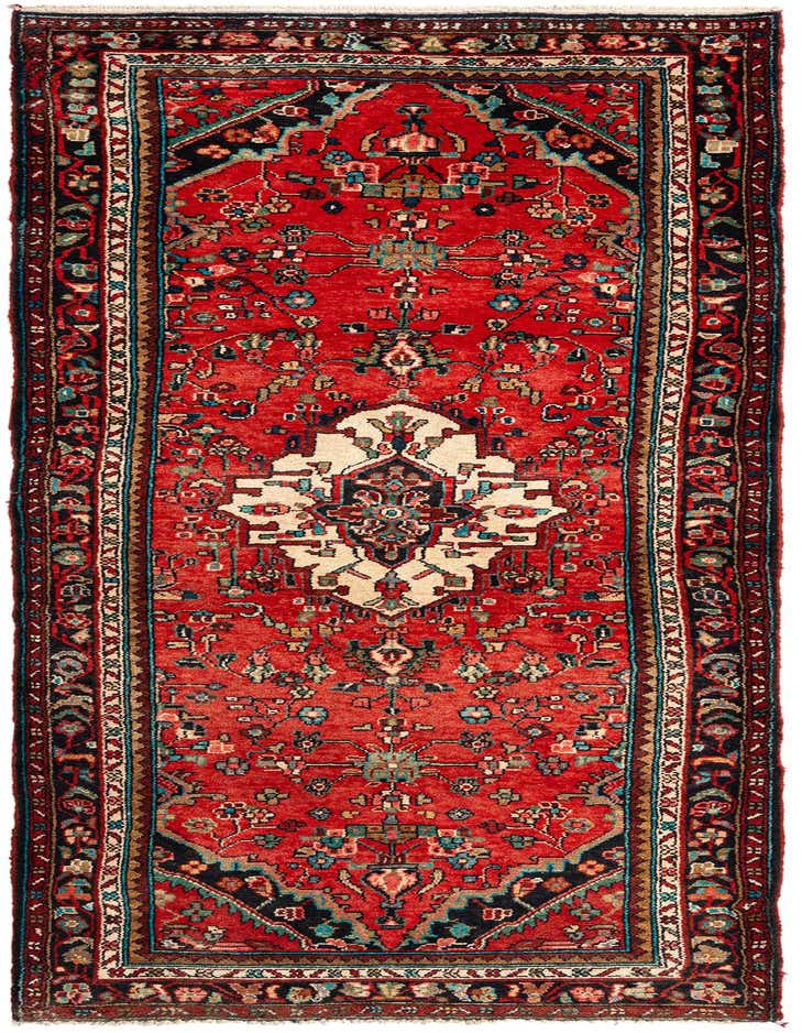 A 10 ft red Persian runner rug with a tribal pattern, featuring a central medallion and intricate floral motifs in black, cream, and teal.