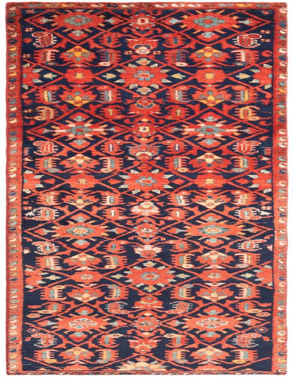 A 10 ft Hamedan runner rug with a traditional tribal pattern in deep red and navy blue, ideal for a hallway.