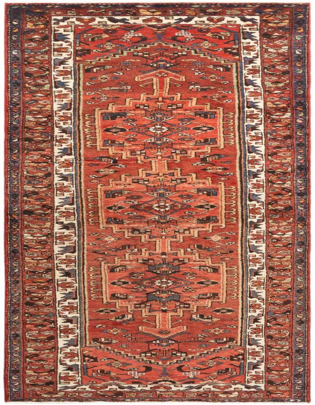A 10 ft Hamedan runner rug in reds and blues with a traditional tribal pattern, perfect for a hallway.
