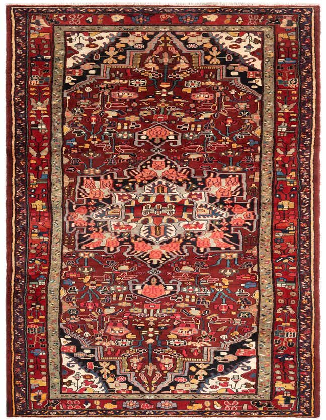 A 14 ft Hamedan runner rug in rich reds with a traditional tribal pattern, perfect for a hallway.
