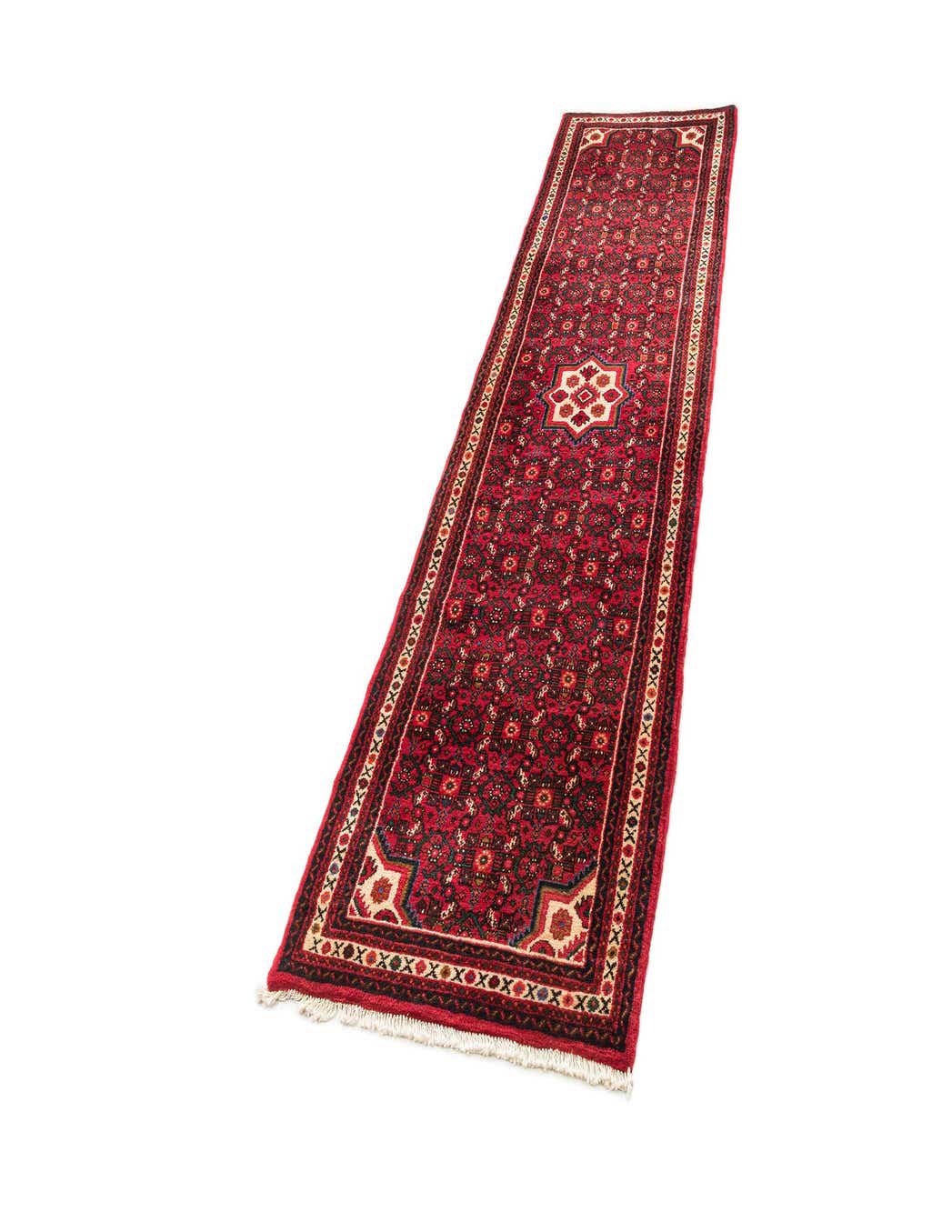 A 10 ft red Hamedan tribal wool runner rug with intricate patterns and a central medallion, ideal for hallways.