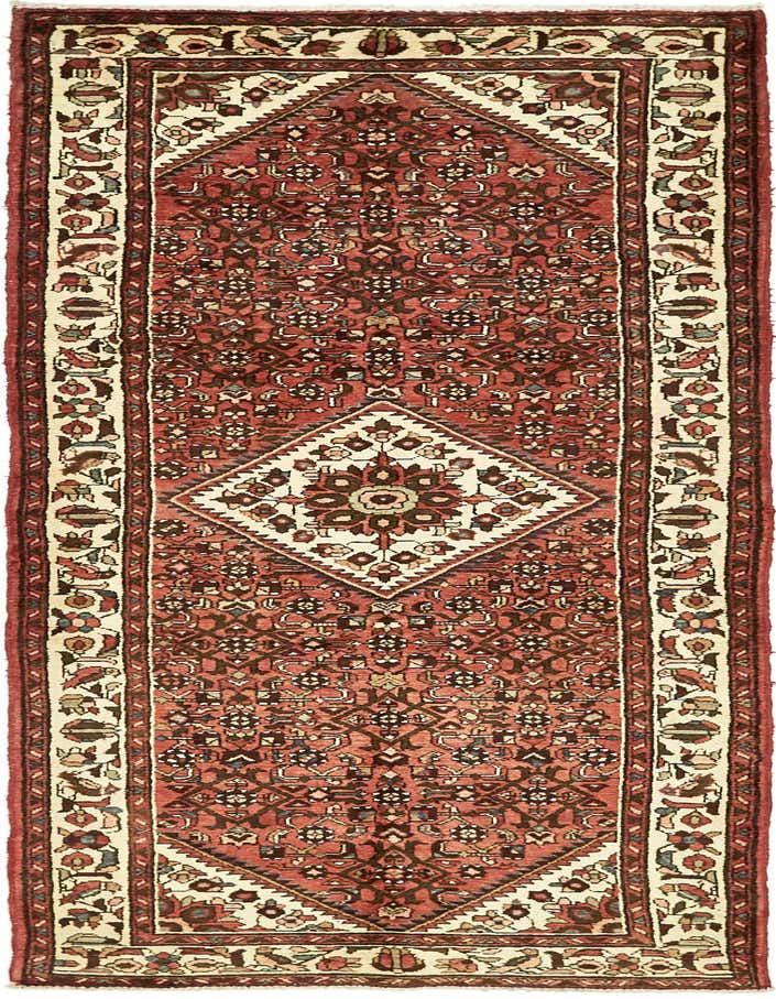 A handmade 11 ft Hossainabad runner rug in reds with a tribal botanical pattern and central medallion, ideal for a hallway.