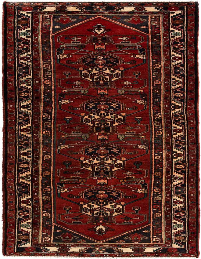 A handmade 11 ft runner rug in shades of red with intricate tribal Persian patterns, ideal for a hallway.