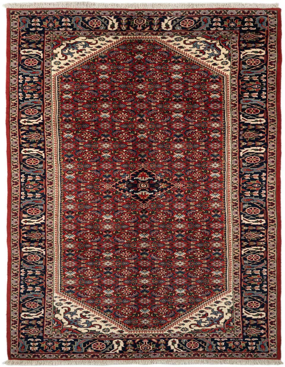 A handmade 11 ft Hossainabad runner rug in deep red with a traditional tribal medallion pattern and navy border.