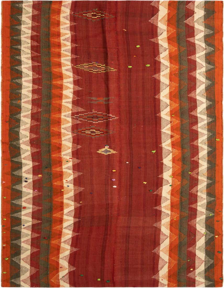 A handmade 11 ft runner rug with a central red field and colorful striped borders featuring zigzag patterns and small geometric motifs.