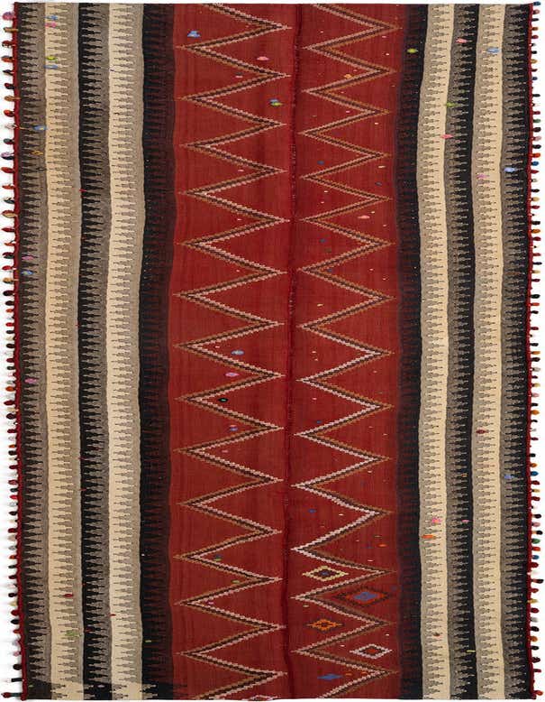 A 16 ft Jajim runner rug with a central red field featuring brown and white zig-zag patterns and colorful accents, flanked by striped borders in beige, black, and brown, with decorative tassels along the sides, ideal for a hallway.