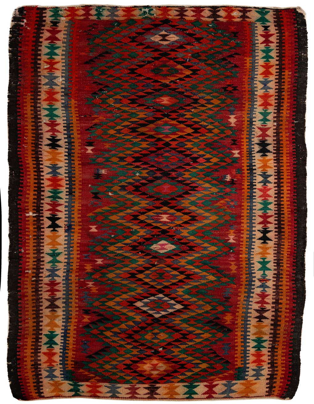 A 9 ft runner rug with a vibrant red base, featuring intricate tribal and geometric patterns in green, orange, black, and blue.