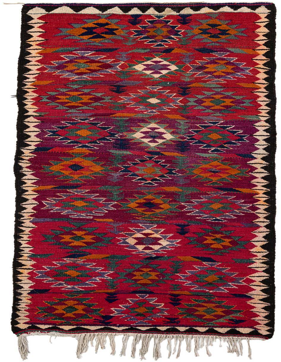 A 10 Ft Kilim Fars runner rug with a vibrant red background and colorful tribal geometric patterns, ideal for a hallway.