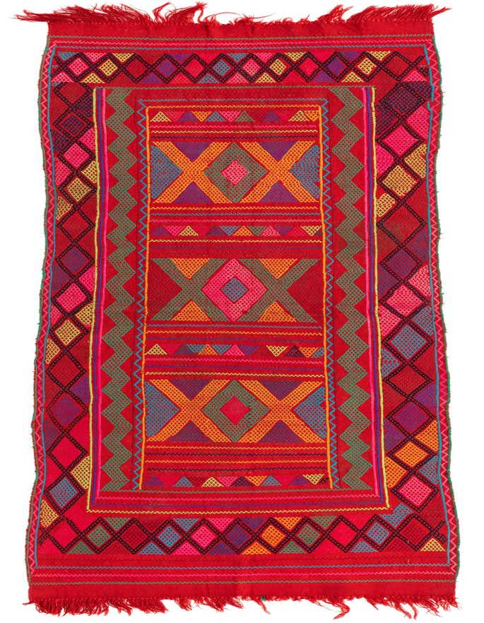 A vibrant 8 ft runner rug with a dominant red background, featuring intricate tribal and geometric patterns in shades of orange, blue, pink, and yellow.