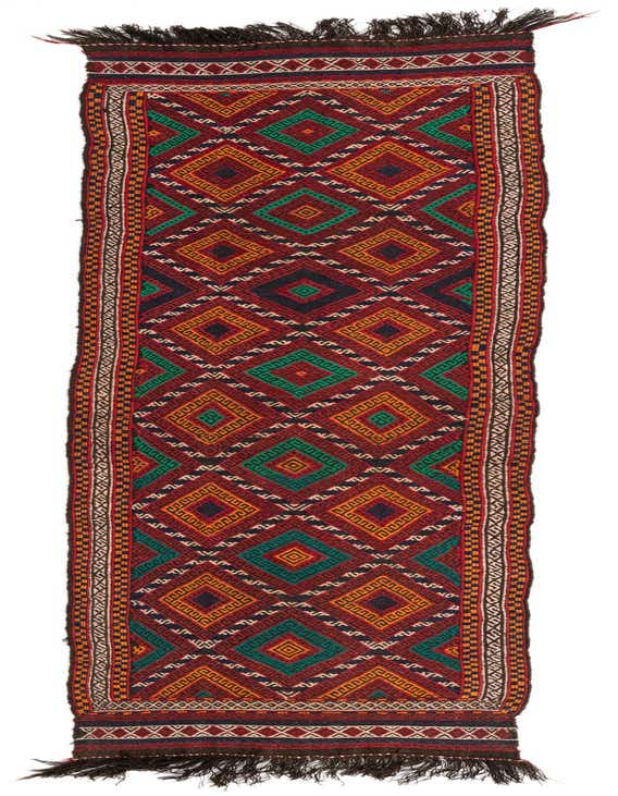 A 10 Ft Kilim Fars runner rug with a vibrant tribal geometric pattern in reds, greens, and oranges, perfect for a hallway.