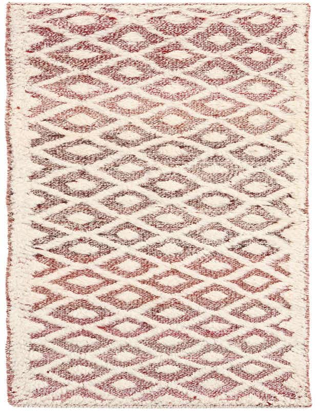 A long, rectangular 8 ft runner rug with a shag pile, featuring a repeating tribal diamond pattern in red and cream.