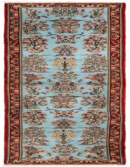 A 13 ft handmade wool runner rug featuring a light blue field with intricate floral and bird motifs, bordered in deep red.