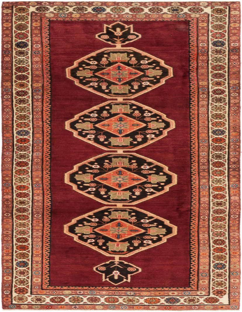 A 10 Ft runner rug from the Shahsavand collection, featuring a rich red field with black and orange tribal medallions, bordered by intricate floral patterns.