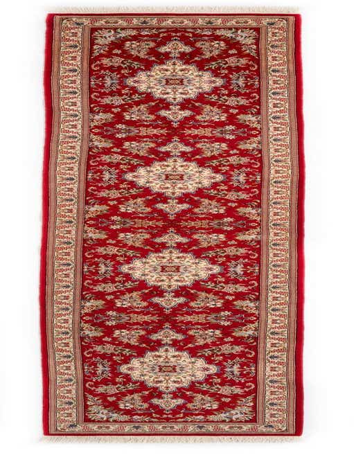 A 13 ft red Persian runner rug with intricate floral and medallion patterns in cream and blue, ideal for a hallway.