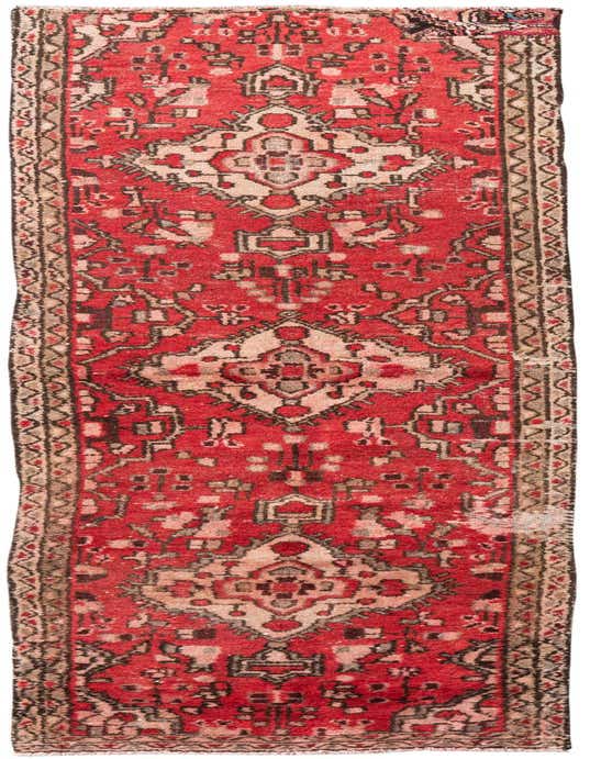 A 9 ft red runner rug with a distressed Persian pattern in cream and dark accents, ideal for a hallway.
