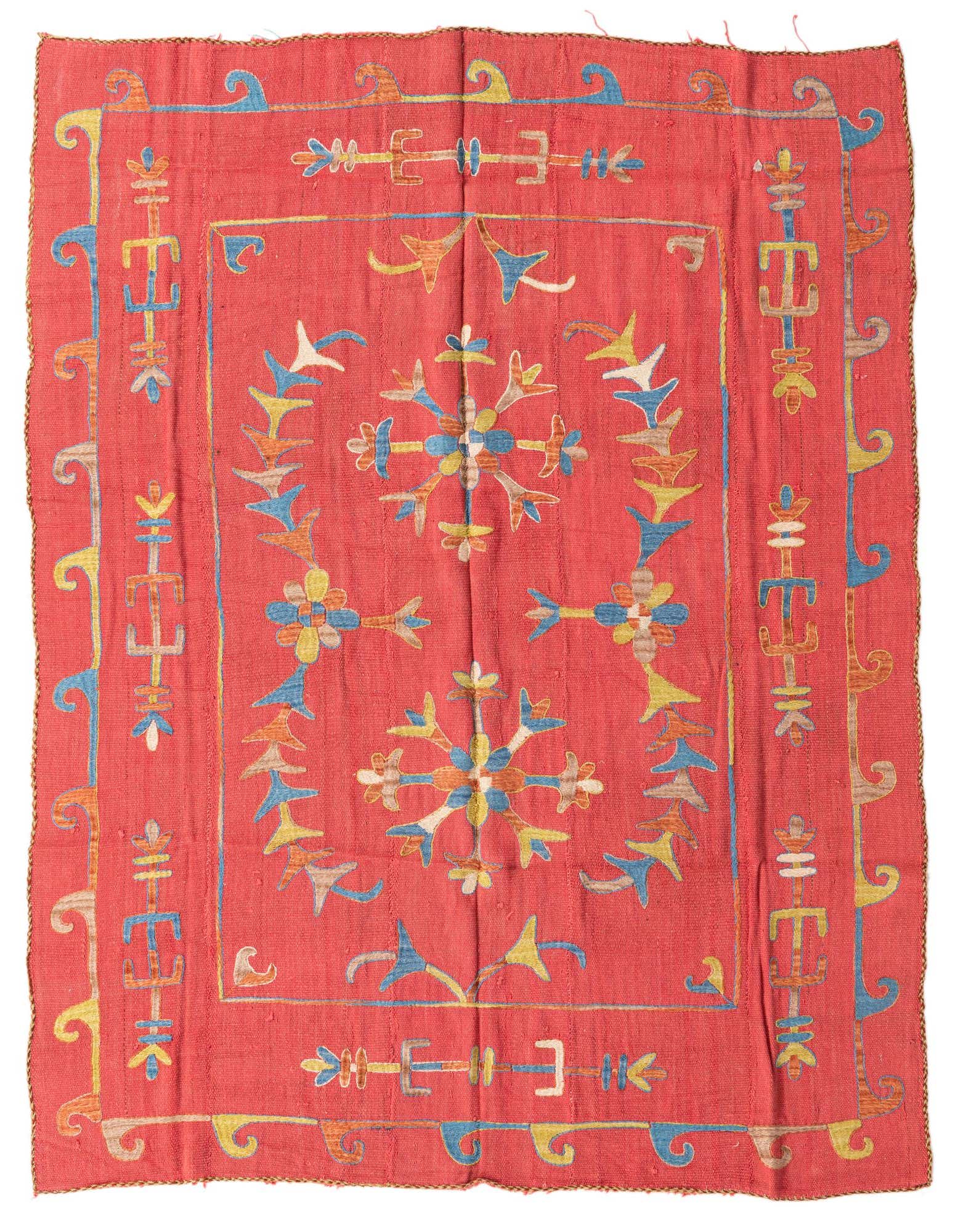 A 5' 6 x 6' 10 square red Kilim Suzani rug with a colorful tribal medallion pattern in blue, yellow, and orange.