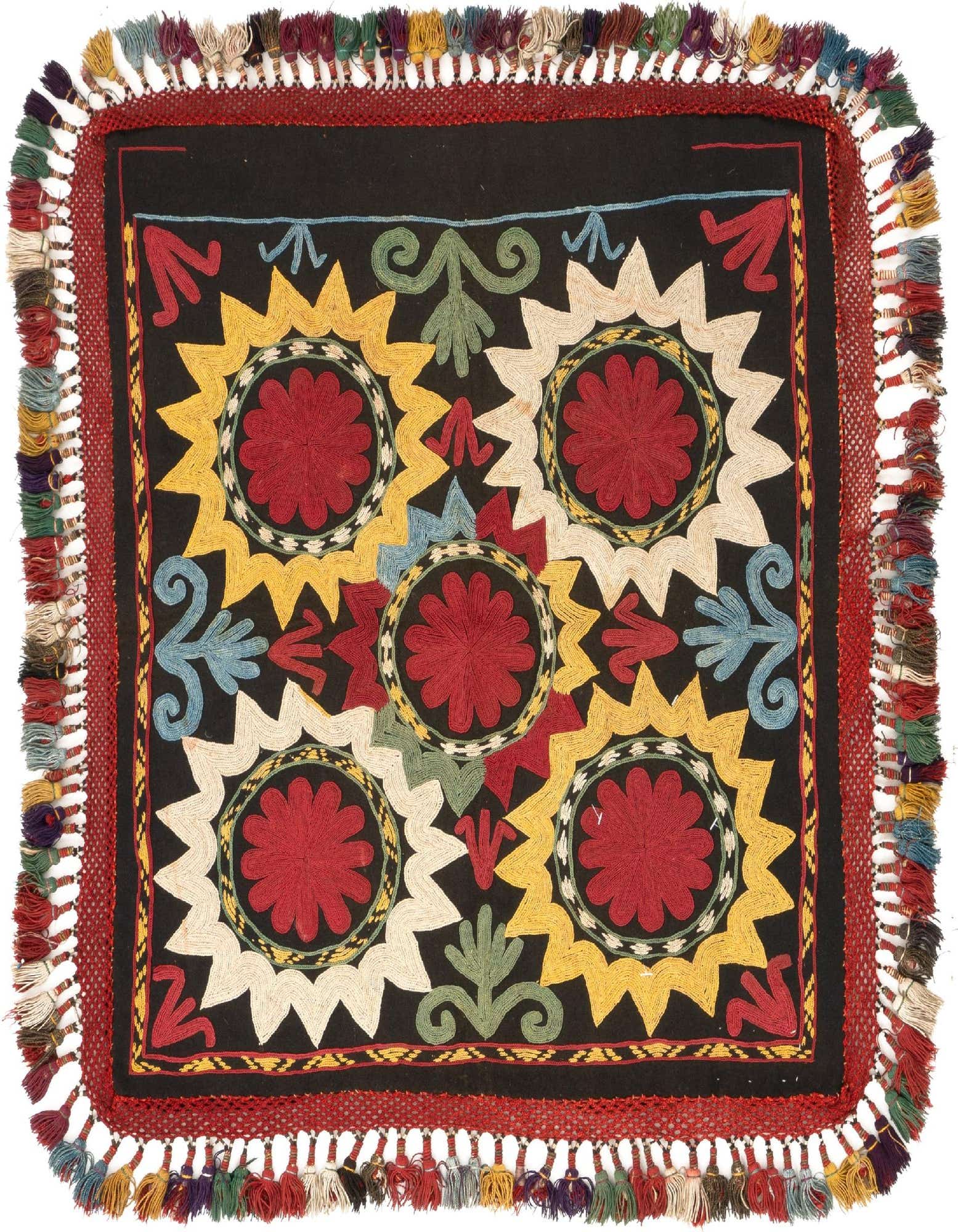 A square Lakai Persian rug, 1'10" x 1'11", featuring a black background with vibrant red, yellow, and cream floral medallions and colorful tassels.