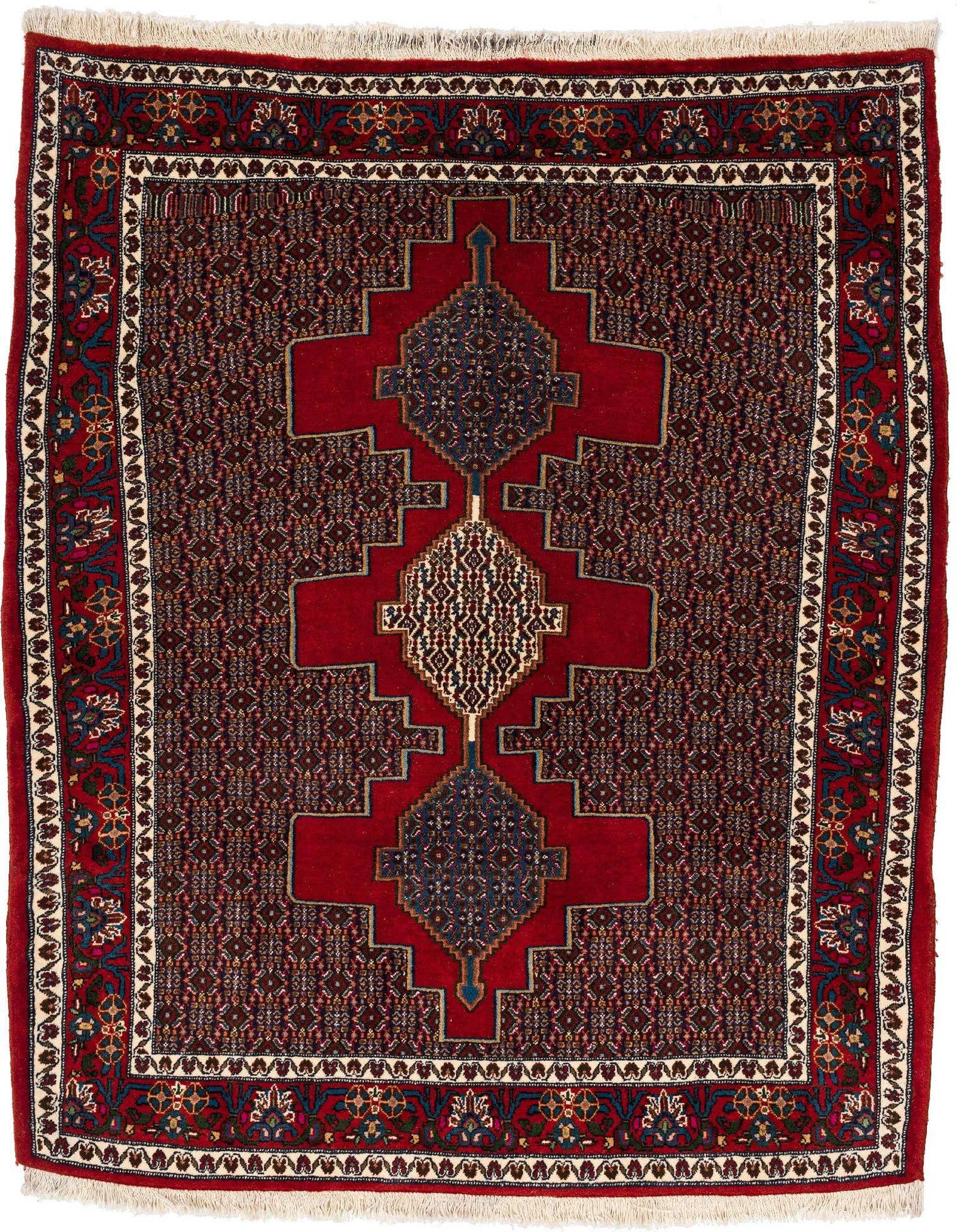 A handmade square Rugs.com Senneh rug featuring a central geometric medallion in red and navy on a dark red field, with intricate patterns and a decorative border.