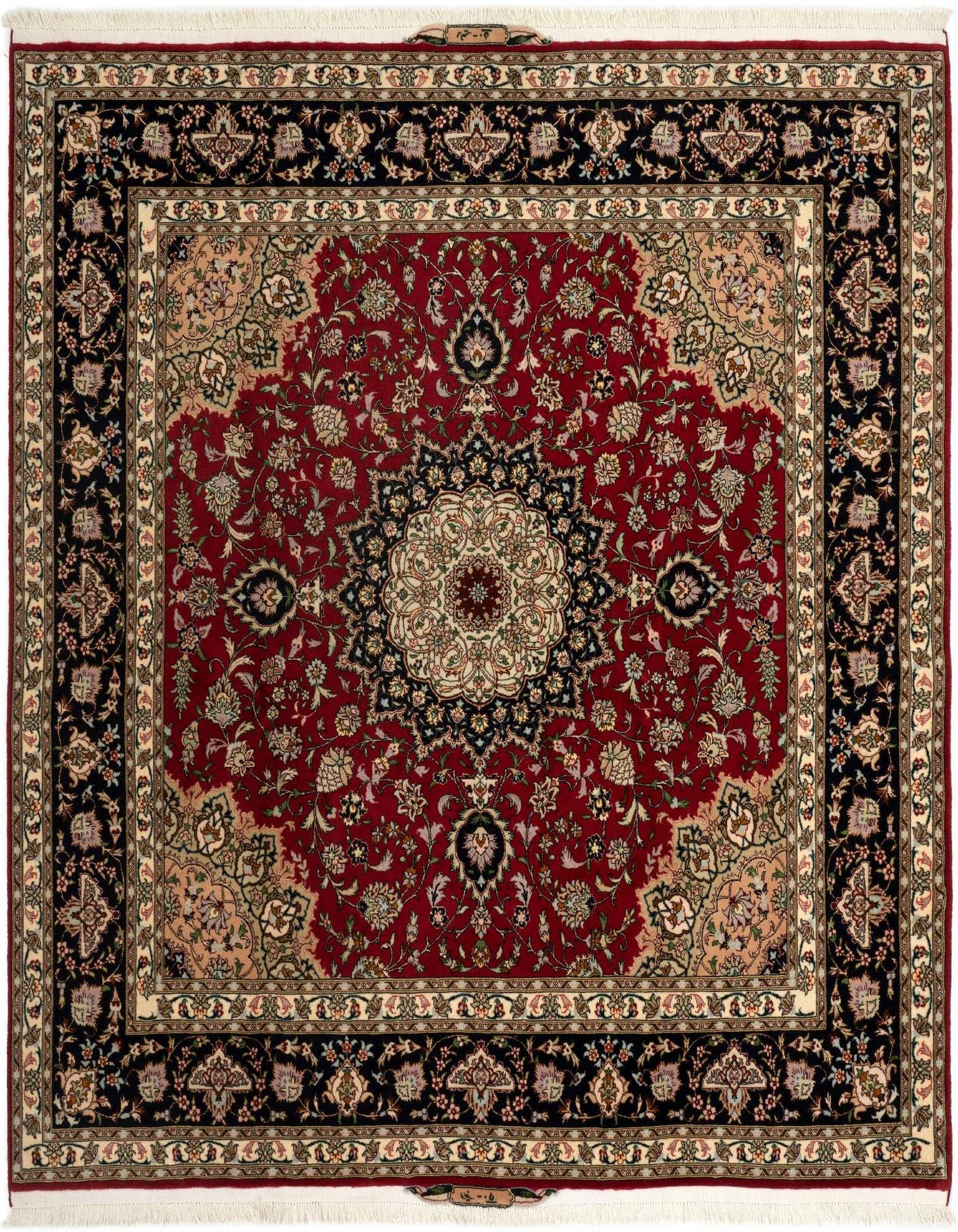 A square 6' 7 x 6' 7 Tabriz rug in red with a detailed black and cream traditional floral medallion pattern.